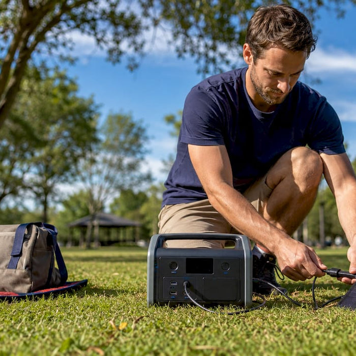 Man setting up solar generator outdoors