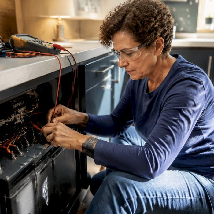 Woman wiring home battery backup unit