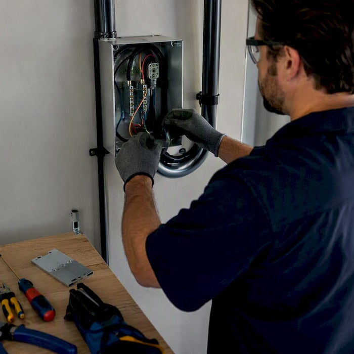 Electrician wiring hardwired EV charger installation