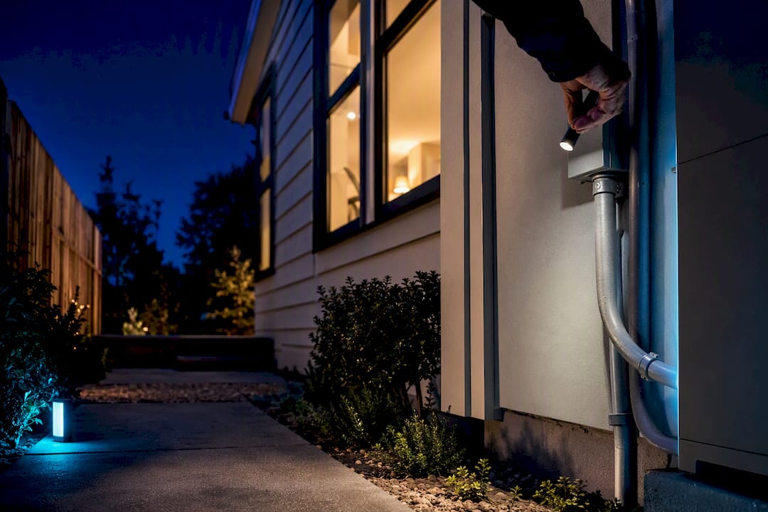 Home battery installation beside residential exterior