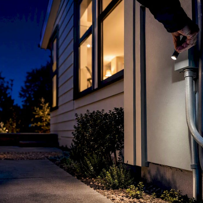 Home battery installation beside residential exterior