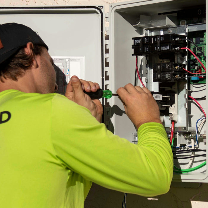 Authorized electrician installing residential electrical panel for EV charger project